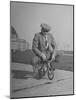 Humorous of Man Riding Tiny Bicycle-Wallace Kirkland-Mounted Photographic Print