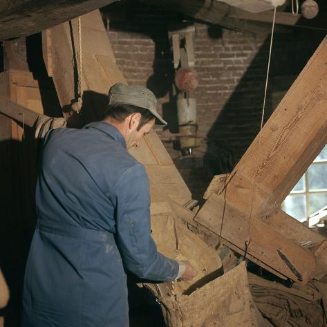 Photographic Print: Miller in 'Mulen van Piet' windmill, 18th century. Artist: Unknown: 16x16in