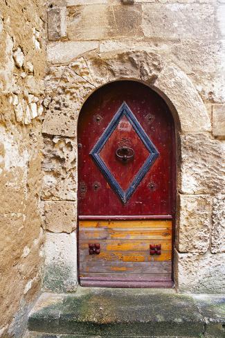 Photographic Print: Colorful door in the stone wall of a chateau in France. by Tom Haseltine: 12x8in