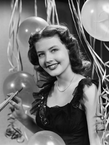 Photographic Print: 1940s 1950s SMILING WOMAN BLACK PARTY DRESS PEARLS HOLDING NEW YEAR PARTY NOISE MAKER STREAMERS. by Panoramic Images: 12x9in Photographic Print: 1940s 1950s SMILING WOMAN BLACK PARTY DRESS PEARLS HOLDING NEW YEAR PARTY NOISE MAKER STREAMERS. by Panoramic Images: 12x9in