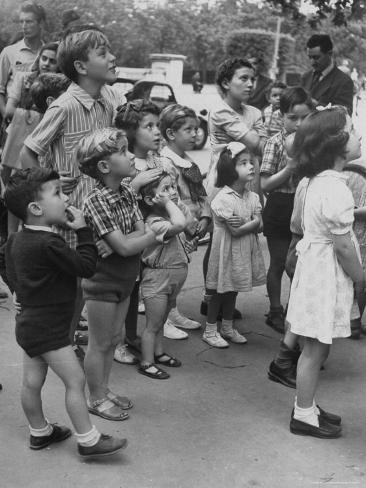 Photographic Print: Italian Kids Watching Outdoor Puppet Show by Dmitri Kessel: 24x18in