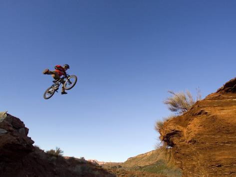 Photographic Print: Mountain Biker Catches Air at Rampage Site near Virgin, Utah, USA by Chuck Haney: 24x18in