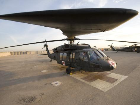 Photographic Print: UH-60 Blackhawk Medivac Helicopter Sits on the Flight Deck at Camp Warhorse by Stocktrek Images: 24x18in