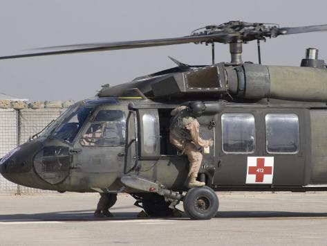 Photographic Print: UH-60 Blackhawk Medivac Helicopter Refuels at Camp Warhorse after a Mission by Stocktrek Images: 24x18in