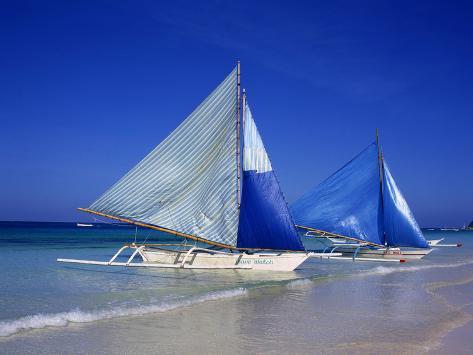 Photographic Print: Boracay beach with traditional sailboats by Charles Bowman: 24x18in