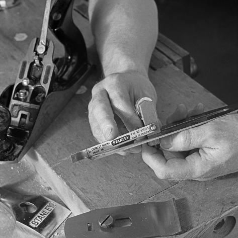 Photographic Print: Using an Adjustment Gauge on a Stanley Plane, 1968 by Michael Walters: 16x16in