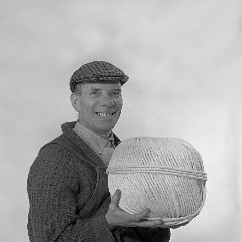 Photographic Print: Yorkshireman Wearing a Flat Cap and Holding a Large Ball of Twine, 1968 by Michael Walters: 16x16in