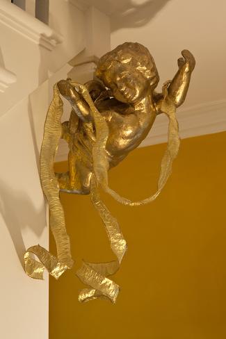 Photo: Gold Ribbon Trailing over Cherub Figure in Corner of Room by Richard Bryant: 24x16in