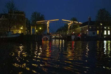 Photographic Print: Night View of Amsterdam Canal with Bridge by Anna Miller: 18x12in