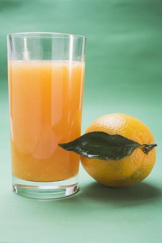 Photographic Print: Glass of Orange Juice Beside Orange with Leaf by Foodcollection: 24x16in