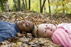 Smiling Children Lying on Autumn Leaves-Ian Boddy-Photographic Print