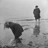 Girl Playing in the Sand while an Older Woman Gets Her Feet Wet in the Ocean at Blackpool Beach-Ian Smith-Photographic Print