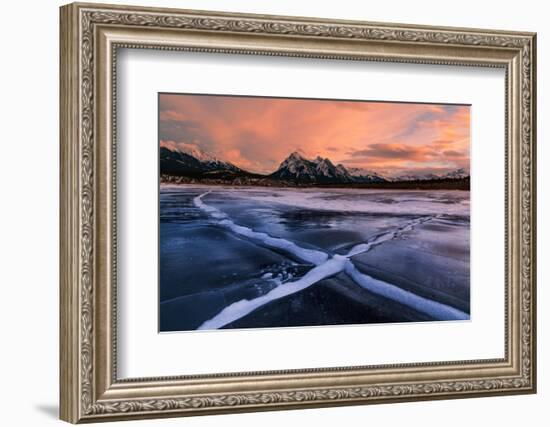 Ice cracks along Abraham Lake in Banff, Canada at sunset with pink clouds and scenic mountains-David Chang-Framed Photographic Print