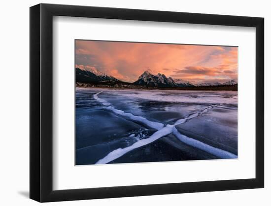 Ice cracks along Abraham Lake in Banff, Canada at sunset with pink clouds and scenic mountains-David Chang-Framed Photographic Print