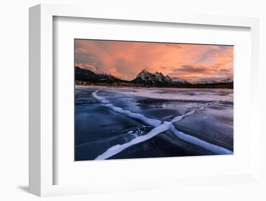 Ice cracks along Abraham Lake in Banff, Canada at sunset with pink clouds and scenic mountains-David Chang-Framed Photographic Print