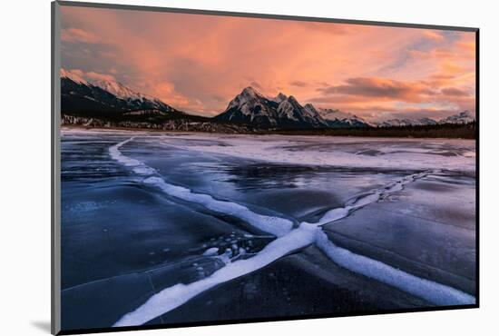 Ice cracks along Abraham Lake in Banff, Canada at sunset with pink clouds and scenic mountains-David Chang-Mounted Photographic Print