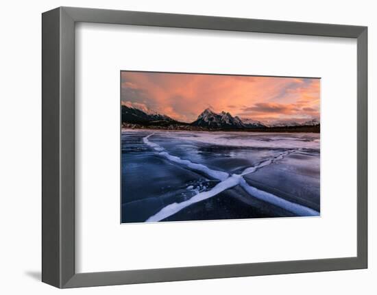 Ice cracks along Abraham Lake in Banff, Canada at sunset with pink clouds and scenic mountains-David Chang-Framed Premium Photographic Print
