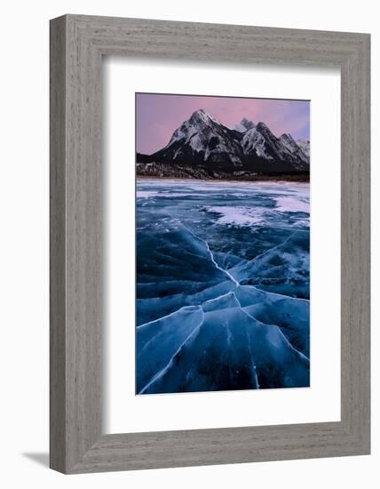 Ice cracks along Abraham Lake in Banff, Canada with purple clouds and scenic mountains-David Chang-Framed Photographic Print