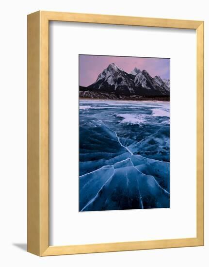 Ice cracks along Abraham Lake in Banff, Canada with purple clouds and scenic mountains-David Chang-Framed Photographic Print