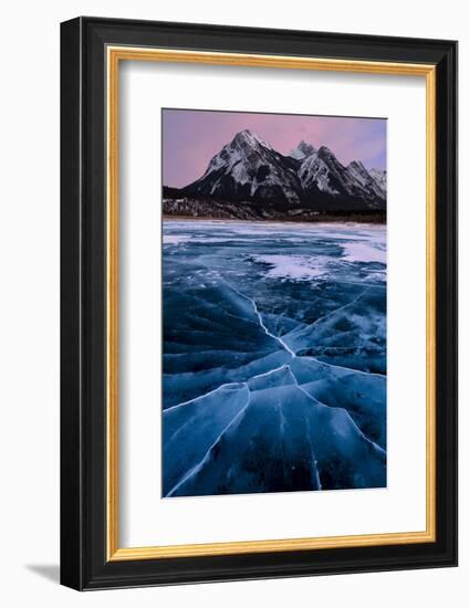 Ice cracks along Abraham Lake in Banff, Canada with purple clouds and scenic mountains-David Chang-Framed Photographic Print