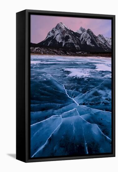 Ice cracks along Abraham Lake in Banff, Canada with purple clouds and scenic mountains-David Chang-Framed Premier Image Canvas