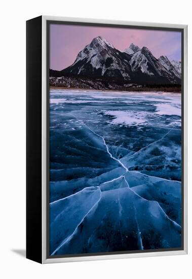 Ice cracks along Abraham Lake in Banff, Canada with purple clouds and scenic mountains-David Chang-Framed Premier Image Canvas