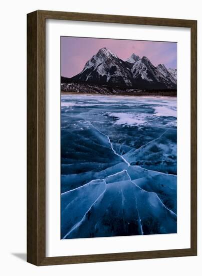 Ice cracks along Abraham Lake in Banff, Canada with purple clouds and scenic mountains-David Chang-Framed Photographic Print