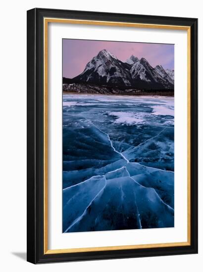 Ice cracks along Abraham Lake in Banff, Canada with purple clouds and scenic mountains-David Chang-Framed Photographic Print