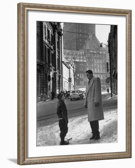 Ice Hockey Player Jean Beliveau, Standing in a Snow Covered Street Speaking to a Child-Yale Joel-Framed Premium Photographic Print