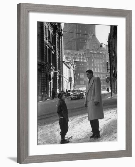 Ice Hockey Player Jean Beliveau, Standing in a Snow Covered Street Speaking to a Child-Yale Joel-Framed Premium Photographic Print