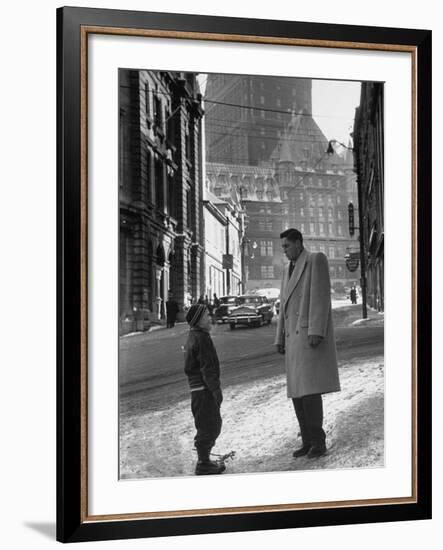 Ice Hockey Player Jean Beliveau, Standing in a Snow Covered Street Speaking to a Child-Yale Joel-Framed Premium Photographic Print