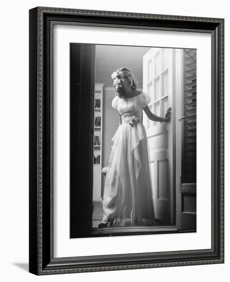 Identical Twin Betty Bounds with Gardenias in her hair and skirt waiting for Her Date-Nina Leen-Framed Photographic Print