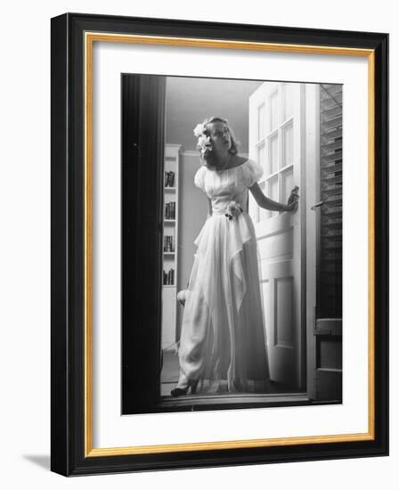 Identical Twin Betty Bounds with Gardenias in her hair and skirt waiting for Her Date-Nina Leen-Framed Photographic Print