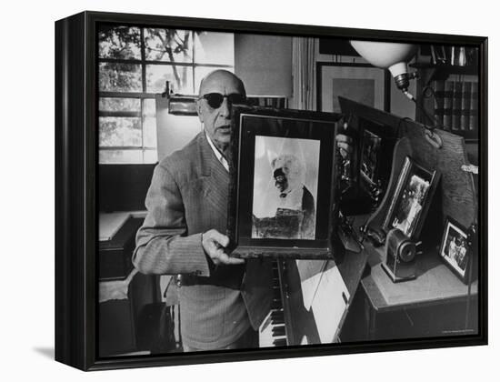 Igor Stravinsky Holding a Negative Image Portrait of Mozart-Gjon Mili-Framed Premier Image Canvas
