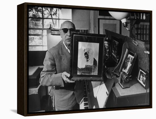 Igor Stravinsky Holding a Negative Image Portrait of Mozart-Gjon Mili-Framed Premier Image Canvas