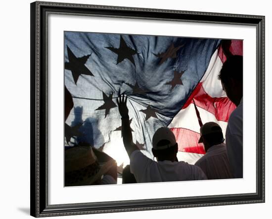 Immigration Rights Demonstrators Hold a U.S. Flag Aloft During a March Along Wilshire Boulevard-null-Framed Photographic Print