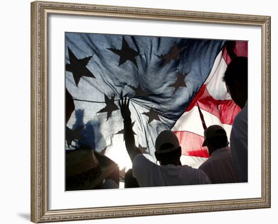 Immigration Rights Demonstrators Hold a U.S. Flag Aloft During a March Along Wilshire Boulevard-null-Framed Photographic Print