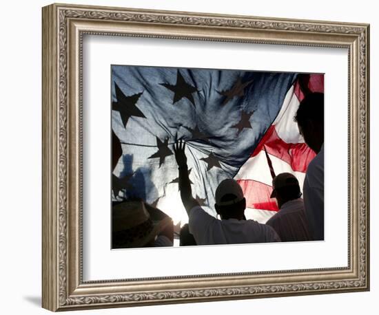 Immigration Rights Demonstrators Hold a U.S. Flag Aloft During a March Along Wilshire Boulevard-null-Framed Photographic Print