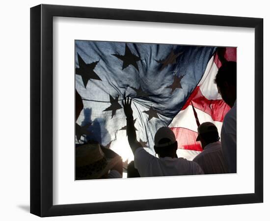 Immigration Rights Demonstrators Hold a U.S. Flag Aloft During a March Along Wilshire Boulevard-null-Framed Photographic Print