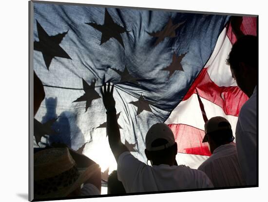 Immigration Rights Demonstrators Hold a U.S. Flag Aloft During a March Along Wilshire Boulevard-null-Mounted Photographic Print