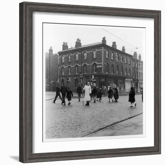 In Liverpool, a Lollipop Lady Helps Children Cross a Cobbled Street-Henry Grant-Framed Photographic Print