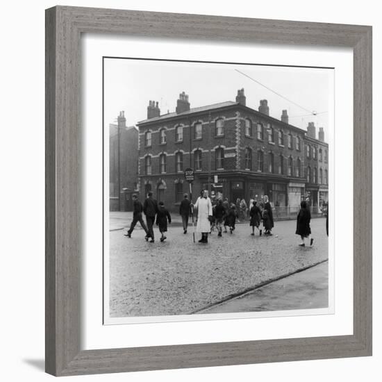 In Liverpool, a Lollipop Lady Helps Children Cross a Cobbled Street-Henry Grant-Framed Photographic Print