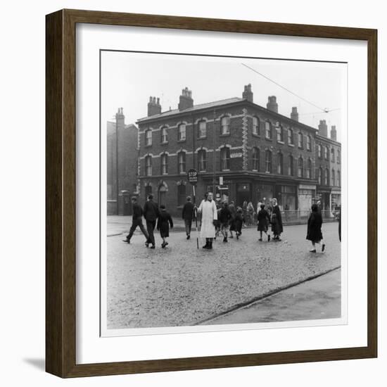 In Liverpool, a Lollipop Lady Helps Children Cross a Cobbled Street-Henry Grant-Framed Photographic Print