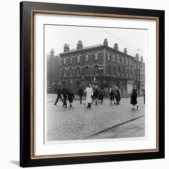 In Liverpool, a Lollipop Lady Helps Children Cross a Cobbled Street-Henry Grant-Framed Photographic Print