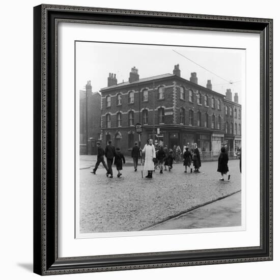 In Liverpool, a Lollipop Lady Helps Children Cross a Cobbled Street-Henry Grant-Framed Photographic Print