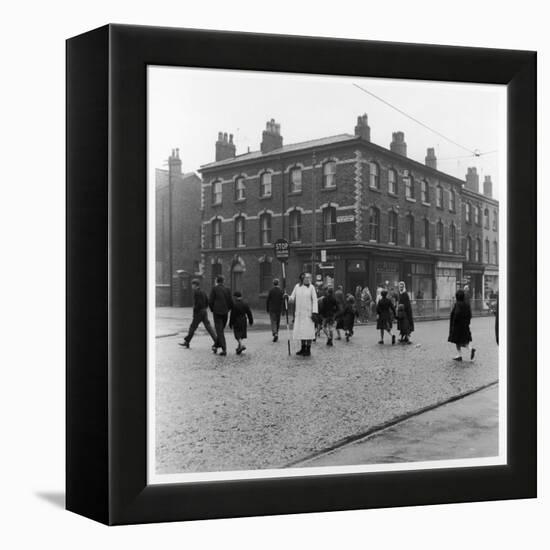 In Liverpool, a Lollipop Lady Helps Children Cross a Cobbled Street-Henry Grant-Framed Premier Image Canvas
