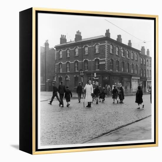 In Liverpool, a Lollipop Lady Helps Children Cross a Cobbled Street-Henry Grant-Framed Premier Image Canvas