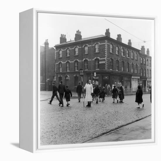 In Liverpool, a Lollipop Lady Helps Children Cross a Cobbled Street-Henry Grant-Framed Premier Image Canvas