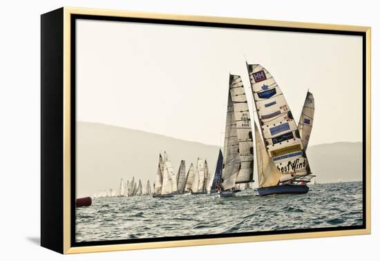 In the start of the yachting regatta Centomiglia in 2012 in front of the harbour of Bogliaco, Lake -Rasmus Kaessmann-Framed Premier Image Canvas