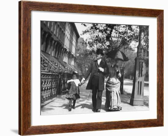 Incredibly Well Dressed Man, Woman and Child Walking by Perfect Brownstone Apartment Buildings-George B^ Brainerd-Framed Photographic Print